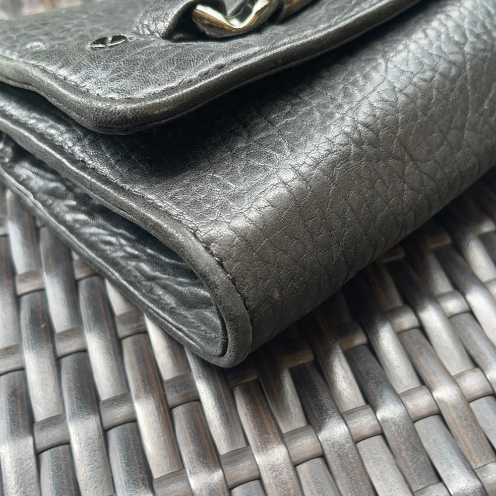 Michael kors Pebbled leather MK clutch with gun metal zipper.